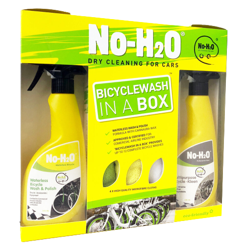 A product packaging for "No-H2O," which offers dry cleaning for cars. The package is labeled "BICYCLEWASH IN A BOX." The box includes two yellow bottles: one for waterless bicycle wash & polish and another for multipurpose bicycle cleaning. There are also features listed on the box, such as "up to 10 complete bike washes." The design also mentions it's eco-friendly and comes with a microfiber cloth.