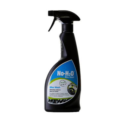 A "No-H2O" spray bottle labeled "Bike Wash." The label indicates it's a waterless bicycle wash & polish that also acts as a harden remover. The design features an image of a clean bike, emphasising its eco-friendly properties.
