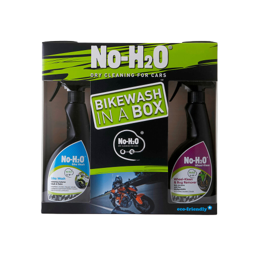 A "No-H2O" product package labeled "Bikewash In A Box." It's designed for dry cleaning bikes. The box includes two spray bottles: one labeled "Bike Wash" with an image of a clean bike, and the other labeled "Wheel & Bug Remover." The package highlights its eco-friendly nature and showcases a motorcycle image in the centre.