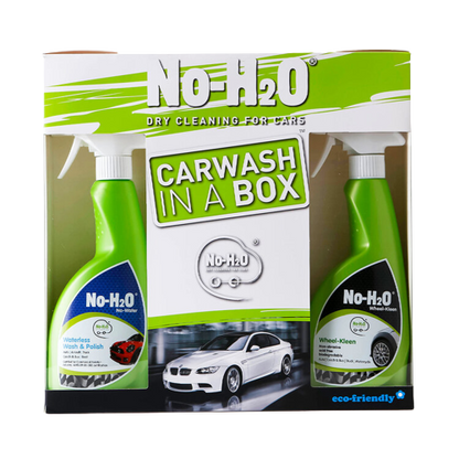 A "No-H2O" Carwash In A Box set. The set includes two products: a "Waterless Wash & Polish" spray and a "Wheel-Kleen" spray. These products are designed for dry cleaning of cars without the need for water, emphasising its eco-friendly attributes. The packaging also showcases a car image, highlighting its primary application.