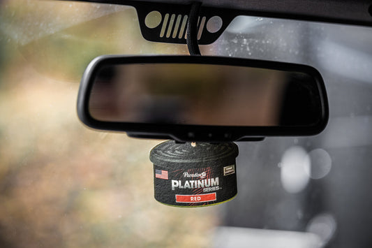 Platinum series paper air freshener attached to a rear view mirror.