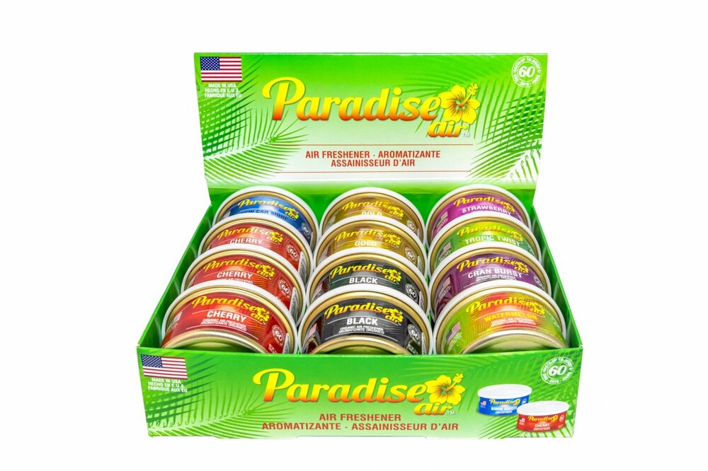 A display box of "Paradise Air" air fresheners. The box contains multiple tins of air fresheners in various scents.